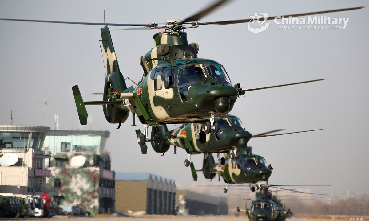 A cluster of Z-9 transport helicopters attached to an army aviation brigade under the PLA 81st Group Army execute hover checks before leaving for a flight training task on November 25, 2021. (eng.chinamil.com.cn/Photo by Chen Kai)