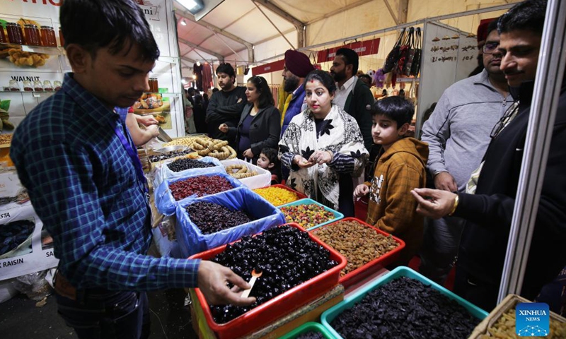 People shop for dried fruit from Afghanistan during the Punjab International Trade Expo (PITEX) in Amritsar, India's northern state Punjab, on Dec 2, 2021. International traders participate in the PITEX 2021 here from Dec 2 to Dec 6.Photo:Xinhua