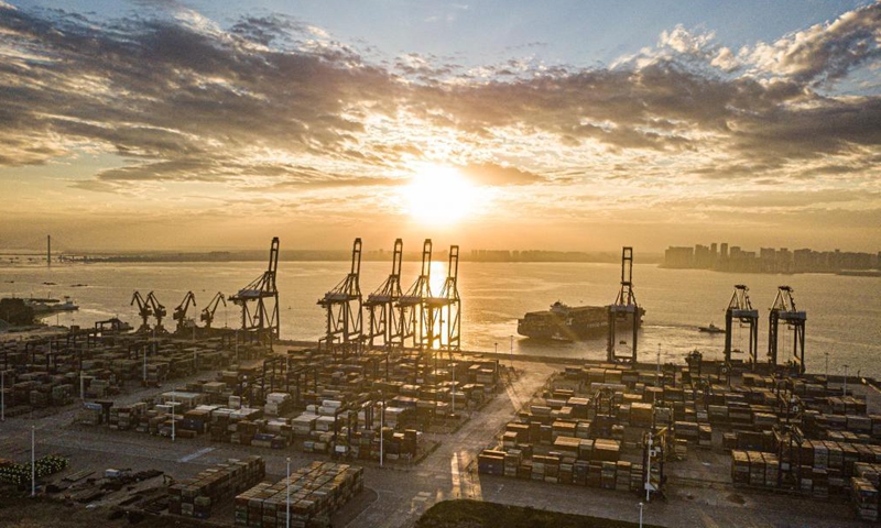 Aerial photo taken on Dec. 5, 2021 shows the sunrise scenery of the Yangpu international container port at Yangpu economic development zone in south China's Hainan Province.Photo:Xinhua