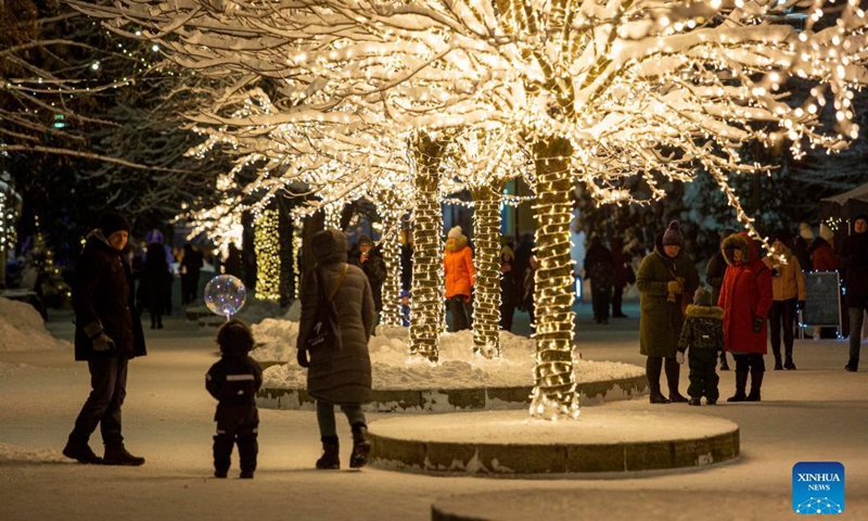 People enjoy Christmas lights in Ogre, Latvia, on Dec. 5, 2021.Photo:Xinhua