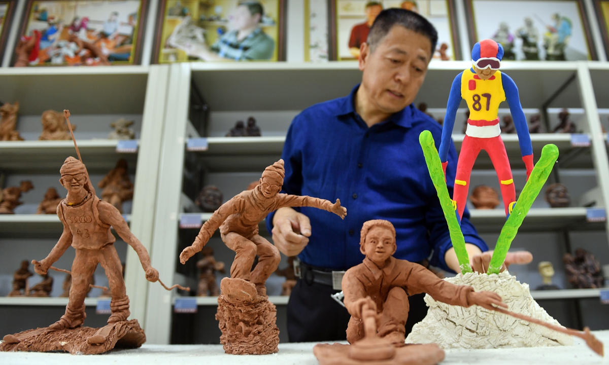 Chinese artist Xie Siguang in Zhangjiakou, North China's Hebei Province, displays his clay sculptures that depict themes related to winter sports on December 8, 2021, as the 2022 Beijing Winter Olympics approaches. Photo: VCG