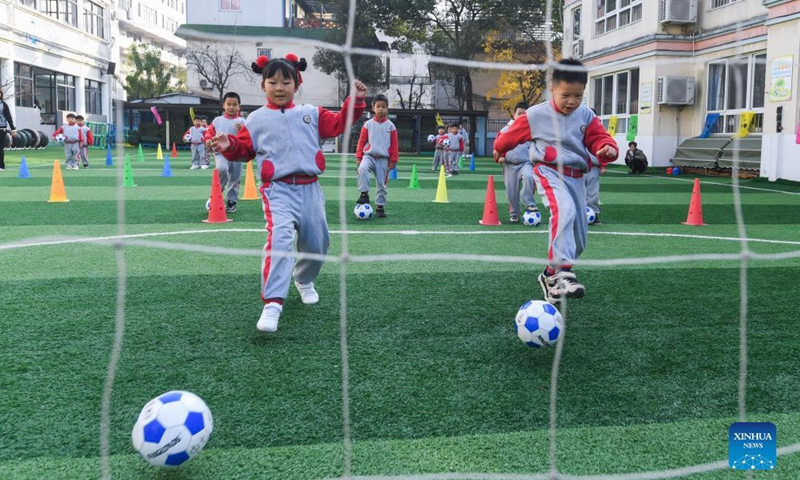 Photo taken on Dec. 8, 2021 shows kids participating in football skills competition. December 9 is World Football Day. In celebration of the event, Central Kindergarten in Changxing County, Huzhou City, east China's Zhejiang province held a week-long football festival, including activities such as dribbling the ball, shooting, running, and passing. Participating children enjoyed the day while learning new football skills. (Xinhua)