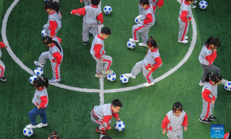 Photo taken on Dec. 8, 2021 shows kids participating in football skills competition. December 9 is World Football Day. In celebration of the event, Central Kindergarten in Changxing County, Huzhou City, east China's Zhejiang province held a week-long football festival, including activities such as dribbling the ball, shooting, running, and passing. Participating children enjoyed the day while learning new football skills. (Xinhua)