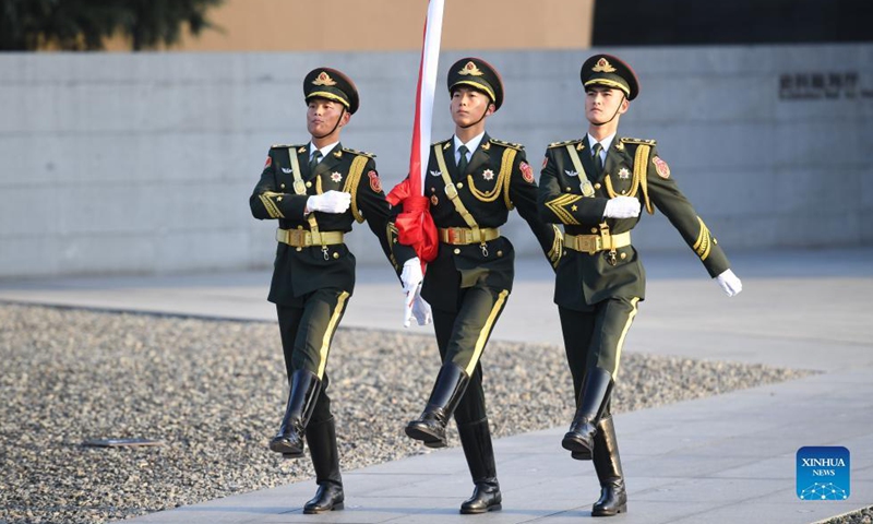 The honor guard escorts the national flag ahead of the national memorial ceremony for the Nanjing Massacre victims at the Memorial Hall of the Victims of the Nanjing Massacre by Japanese Invaders in Nanjing, capital of east China's Jiangsu Province, Dec. 13, 2021.Photo:Xinhua