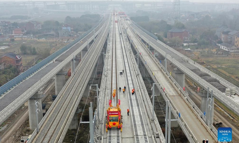 Workers of the China Railway No.4 Engineering Group lay the track of the Huzhou-Hangzhou high-speed railway in Yuhang District, Hangzhou City of east China's Zhejiang Province, Dec. 16, 2021.Photo:Xinhua