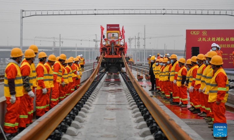 Workers of the China Railway No.4 Engineering Group lay the track of the Huzhou-Hangzhou high-speed railway in Yuhang District, Hangzhou City of east China's Zhejiang Province, Dec. 16, 2021.Photo:Xinhua