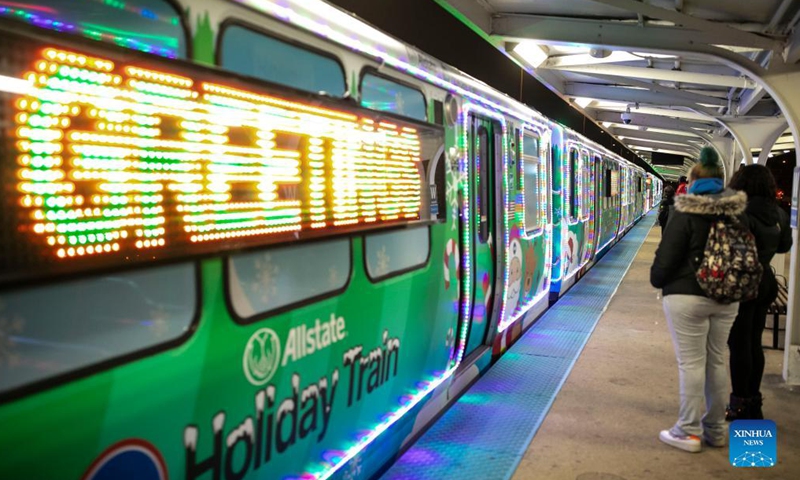 The Holiday Train pulls into Western Ave station on the Blue Line in Chicago, the United States, Dec. 18, 2021. The year of 2021 marks the 30th anniversary for the Holiday Train service by Chicago Transit Authority. (Photo by Joel Lerner/Xinhua)