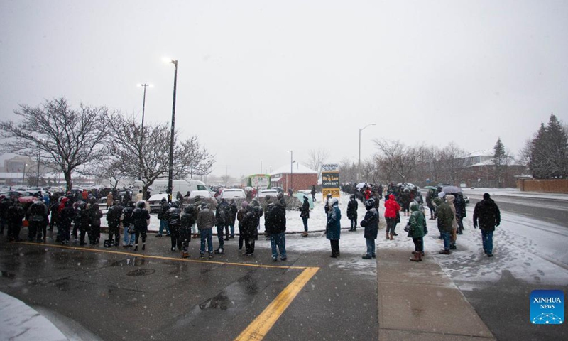 People line up to pick up free COVID-19 antigen rapid test kits in Mississauga, Ontario, Canada, on Dec. 18, 2021.Photo:Xinhua