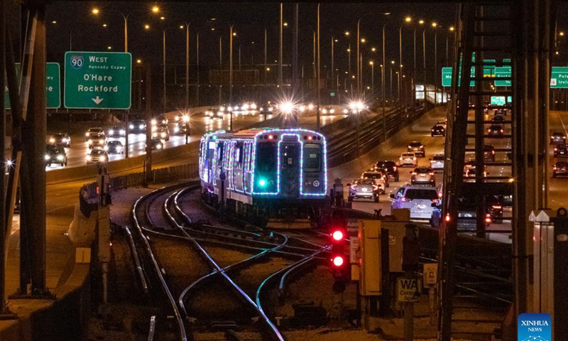 The Holiday Train leaves the Addison station on the Blue Line in Chicago, the United States, Dec. 18, 2021. The year of 2021 marks the 30th anniversary for the Holiday Train service by Chicago Transit Authority. (Photo by Joel Lerner/Xinhua)