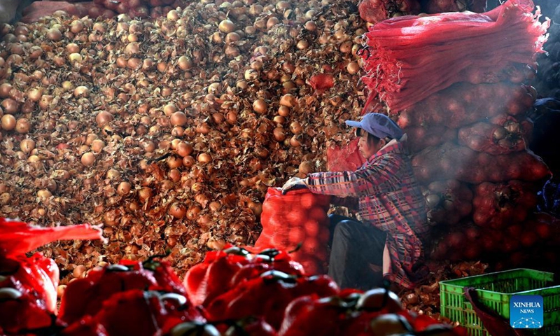A staff member packs vegetable at a logistics center in Xi'an, northwest China's Shaanxi Province, Dec. 19, 2021.Photo:Xinhua
