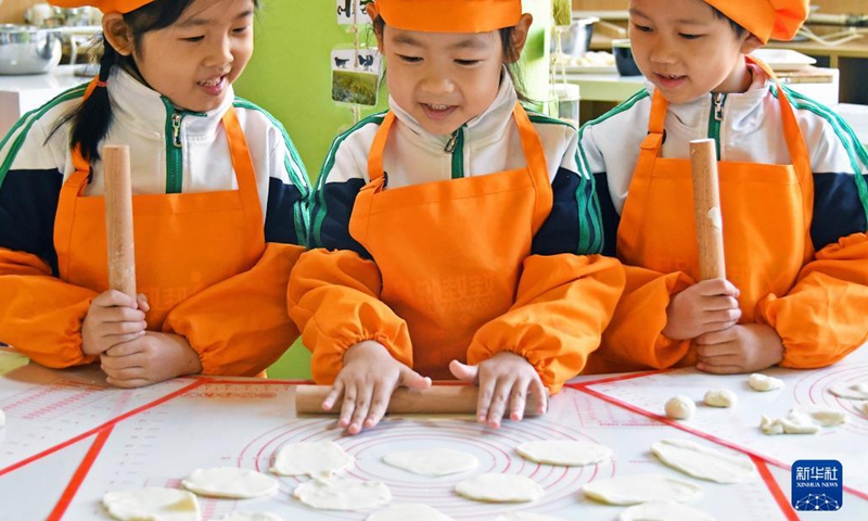 Children learn to make dumplings in celebration of the Winter Solstice or Dongzhi in their kindergarten in Yantai, east China's Shandong Province, Dec. 20, 2021. Winter Solstice, the shortest day of the year, falls on Dec. 21 this year. In Chinese culture, it marks the beginning of deep winter. It is also a time for family gatherings.(Photo: Xinhua)