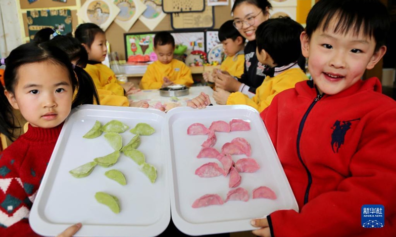 Children learn to make dumplings in celebration of the Winter Solstice or Dongzhi in their kindergarten in Lianyungang, east China's Jiangsu Province, Dec. 20, 2021. Winter Solstice, the shortest day of the year, falls on Dec. 21 this year. In Chinese culture, it marks the beginning of deep winter.(Photo: Xinhua)