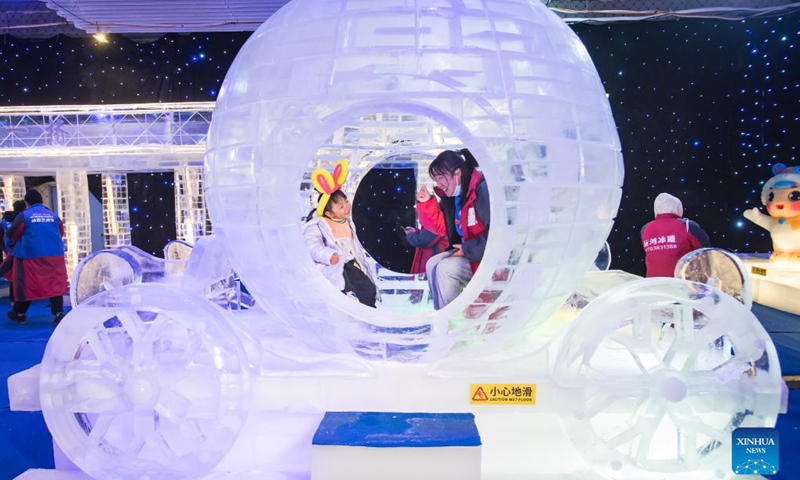 People visit an ice and snow art festival in Wuhan, capital of central China's Hubei Province, Dec. 21, 2021. As part of the 8th National Public Ice and Snow Season, the ice and snow art festival kicked off here on Tuesday.(Photo: Xinhua)