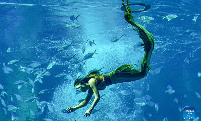 A contestant participates in the final of China's First Mermaid Performance Contest in Sanya, south China's Hainan Province, Dec. 22, 2021. The event, the first national-level professional mermaid competition, was held at Atlantis Sanya in Hainan.(Photo: Xinhua)