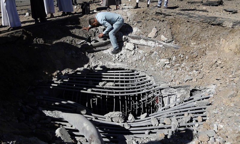 People inspect the explosion site at the al-Sabeen flyover in Sanaa, Yemen's capital on Dec. 23, 2021.(Photo: Xinhua)