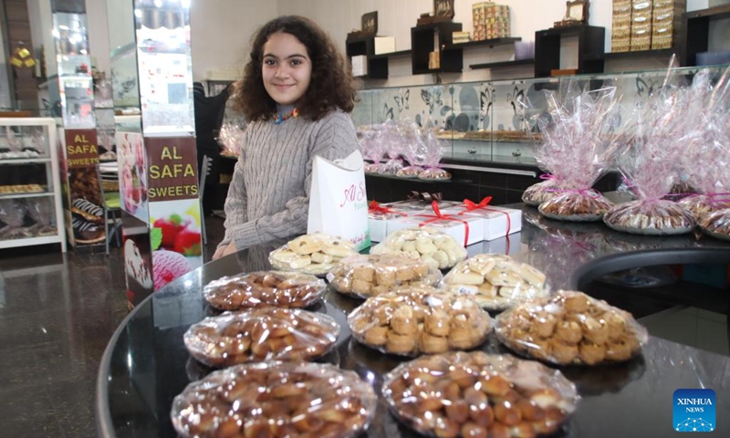 A girl buys sweets inside a sweets shop in the city of Nabatiyeh, southern Lebanon, on Dec. 22, 2021. Sweets shops see increase in prices this year in light of the deteriorating economic situation in Lebanon.(Photo: Xinhua)