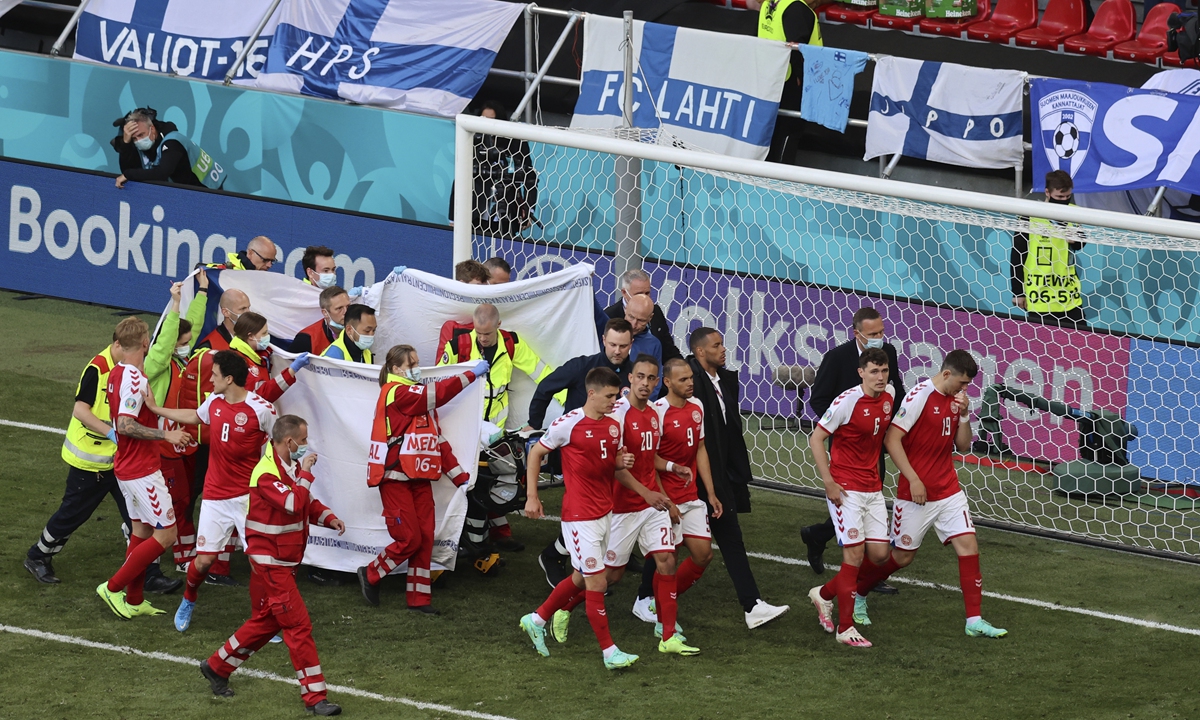 Paramedics using a stretcher to take Christian Eriksen out of the pitch after he collapsed in Copenhagen, Denmark on June 12, 2021. Photo: VCG