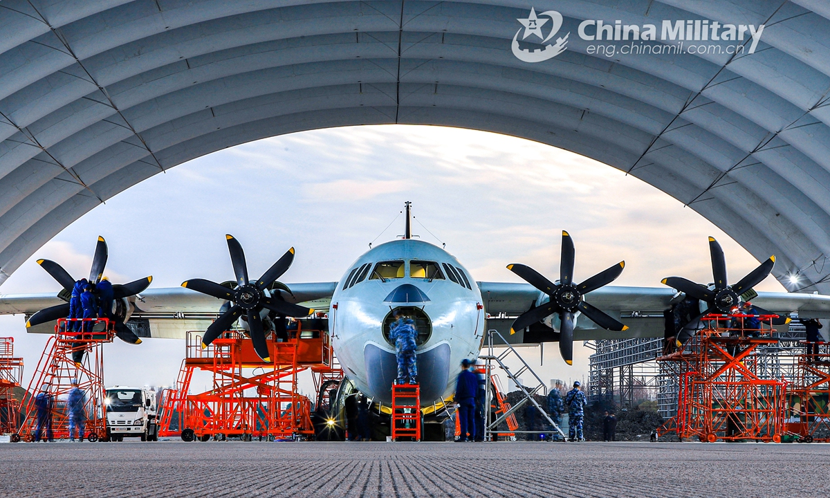 Maintenance men assigned to an aviation division with the PLA Navy perform inspections on an anti-submarine patrol aircraft in the hangar in late December. (eng.chinamil.com.cn/Photo by Zhang Dingyi)