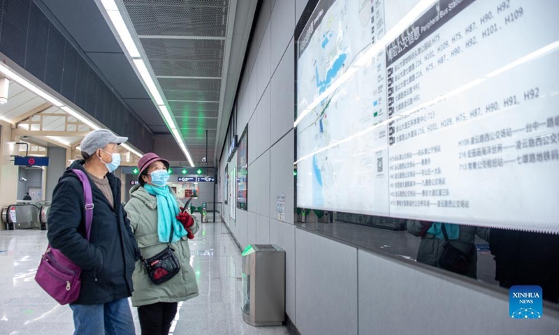 Passengers look on route information at the Matoutan Park Station of the Metro Line 6 (second phase) in Wuhan, central China's Hubei Province, Dec. 26, 2021.Photo:Xinhua