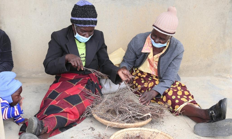 Members of the Women's Farming Syndicate (WFS) prepare traditional herbs in Domboshava, Mashonaland East Province, Zimbabwe, on Dec. 21, 2021.(Photo: Xinhua)