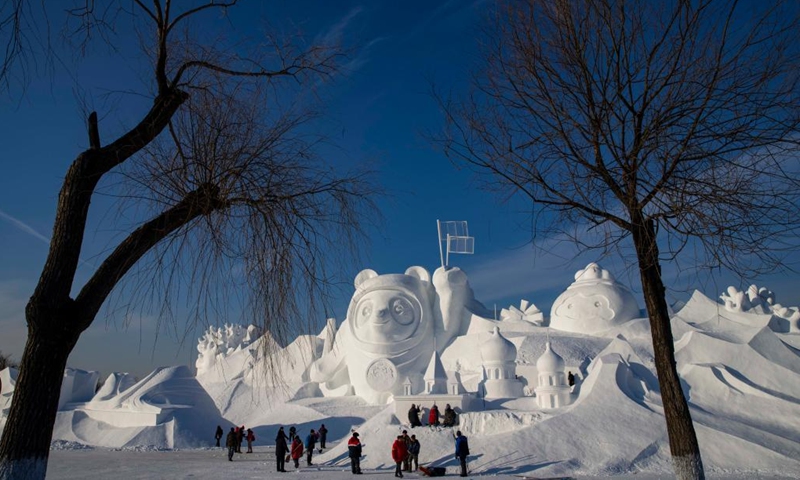 Workers finish the main snow sculpture featuring Beijing 2022 mascots at the 34th Harbin Sun Island International Snow Sculpture Art Exposition in Harbin, northeast China's Heilongjiang Province, Dec. 28, 2021. (Xinhua/Zhang Tao)