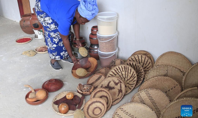 Tsitsi Machingauta, Founder and National Coordinator of the Women's Farming Syndicate (WFS), shows handicrafts made by women in Domboshava, Mashonaland East Province, Zimbabwe, on Dec. 21, 2021.(Photo: Xinhua)