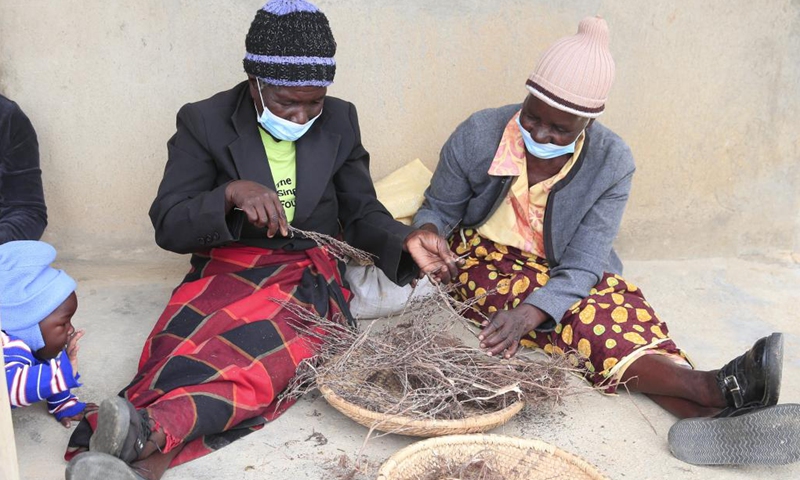 Members of the Women's Farming Syndicate (WFS) prepare traditional herbs in Domboshava, Mashonaland East Province, Zimbabwe, on Dec. 21, 2021.(Photo: Xinhua)