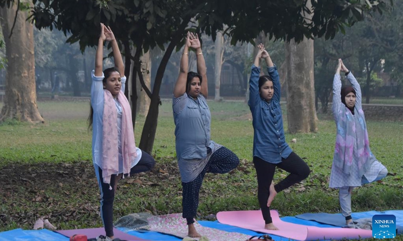 People do morning exercise at a park in Dhaka, Bangladesh, on Dec 30, 2021.Photo:Xinhua