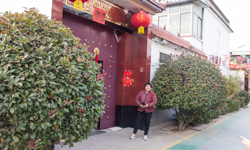 Hougang villager Jin Shiling stands outside her house. Photo: Shan Jie/GT