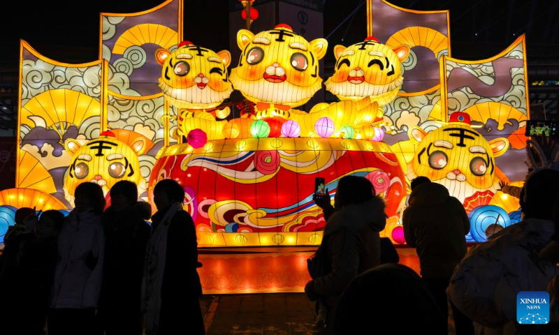 People visit a lantern show at the Xinjiang International Convention and Exhibition Center in Urumqi, northwest China's Xinjiang Uygur Autonomous Region, Jan. 1, 2022. (Xinhua/Hu Huhu)