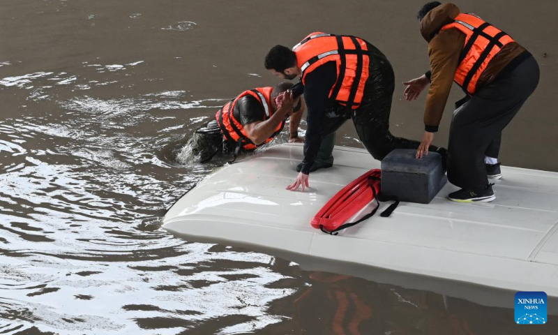 Cars are trapped on a flooded road caused by heavy rain in Farwaniya Governorate, Kuwait, Jan. 2, 2022.