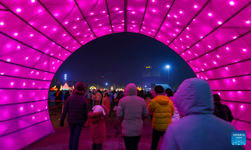 People visit a lantern show at the Xinjiang International Convention and Exhibition Center in Urumqi, northwest China's Xinjiang Uygur Autonomous Region, Jan. 1, 2022. (Xinhua/Hu Huhu)