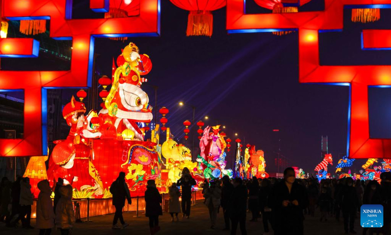 People visit a lantern show at the Xinjiang International Convention and Exhibition Center in Urumqi, northwest China's Xinjiang Uygur Autonomous Region, Jan. 1, 2022. (Xinhua/Hu Huhu)