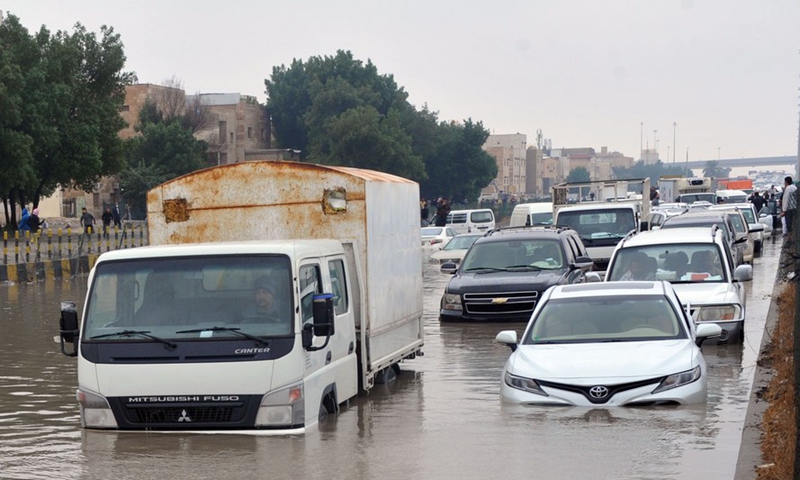 Cars drive in flood on a street in Farwaniya Governorate, Kuwait, on Jan. 2, 2022.Photo:Xinhua