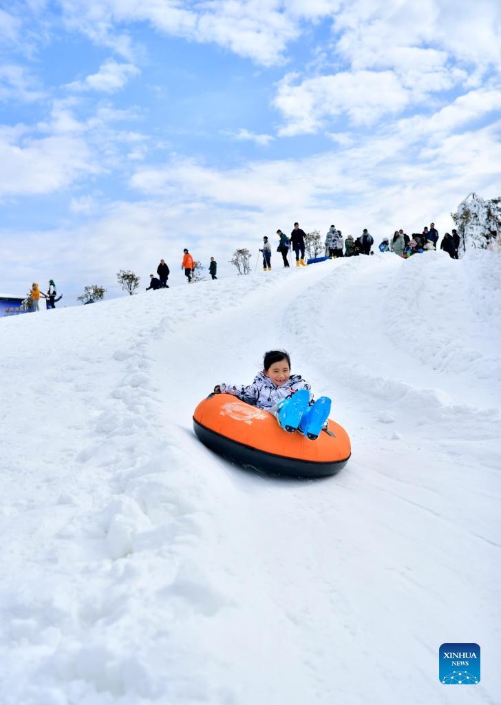 A girl enjoys playing on snow tube at a ski resort in Enshi, central China's Hubei Province, Jan. 3, 2022.Photo:Xinhua