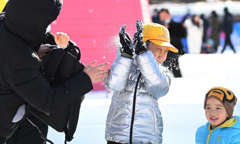 Children play with snow at an ice and snow carnival held in Taoranting Park during the New Year holiday in Beijing, capital of China, Jan. 2, 2022.Photo:Xinhua