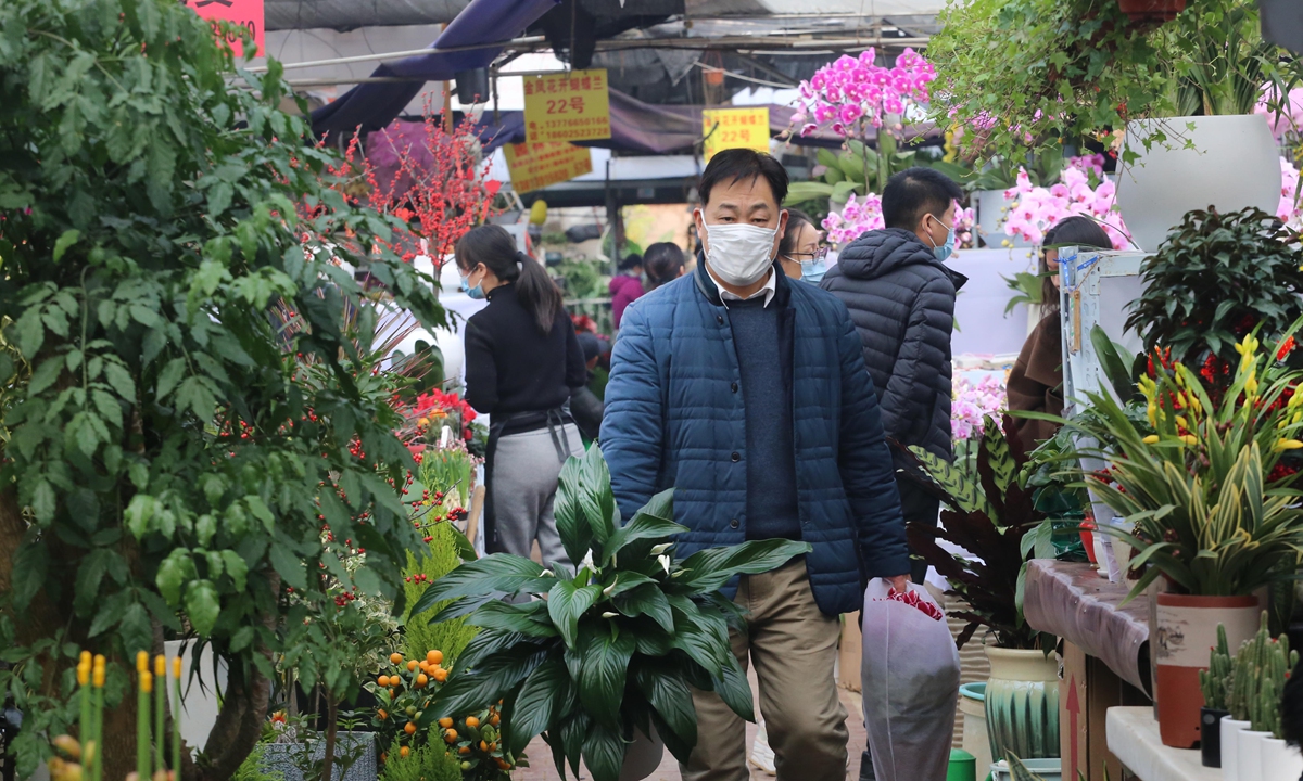 A man tours a flower market in Nanjing, East China's Jiangsu Province on January 3, 2022. Consumers across China are shopping for flowers to decorate their homes for the New Year. China's flower industry has grown steadily in recent years, and the e-commerce segment alone is estimated to be valued at 50 billion yuan ($7.87 billion). Photo: VCG