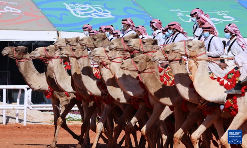 People ride camels for a parade during the King Abdulaziz Camel Festival in north of Riyadh, Saudi Arabia, on Jan. 5, 2022. The festival kicked off here on Dec. 1, 2021, with the participation of about 33,000 camel owners.(Photo: Xinhua)