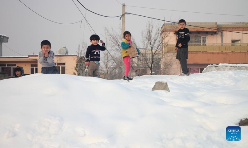 Children play with snow in Kabul, Afghanistan, Jan. 5, 2022. Heavy snow started falling across the country on Monday, bringing new hardships to needy families who have little food to eat and no way to heat their makeshift shelters. Many with no choice but to scavenge on the streets of Kabul.(Photo: Xinhua)