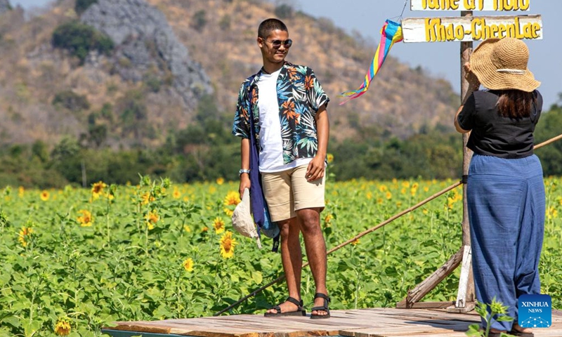 Tourists are seen in sunflower fields in Lopburi, Thailand, Jan. 6, 2022. Lopburi province is famous for a large sunflower plantation in Thailand. From November to January, the golden sunflower fields attract many tourists.Photo:Xinhua