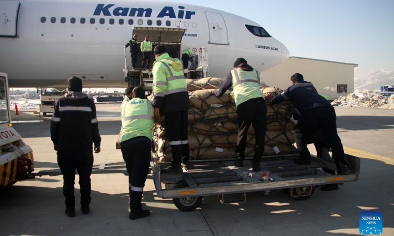 Workers load pine nuts into a plane at Kabul International Airport in Kabul, Afghanistan, on Jan. 10, 2022. A cargo flight carrying a fresh shipment of pine nuts left Kabul for China on Monday, authorities said.(Photo: Xinhua)