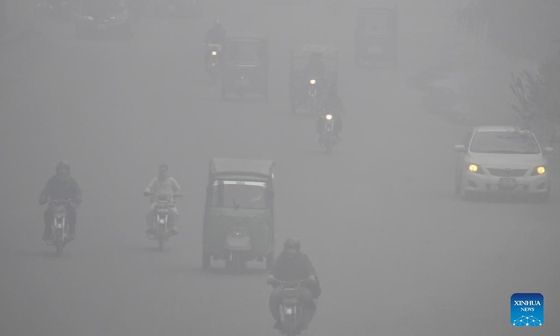 Vehicles move on a road in dense fog in Lahore, Pakistan, on Jan. 13, 2022.(Photo: Xinhua)