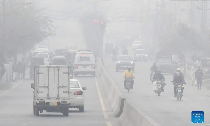 Vehicles move on a road in dense fog in Lahore, Pakistan, on Jan. 13, 2022.(Photo: Xinhua)