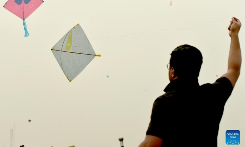 A man flies a kite during Sakrain festival in Dhaka, capital of Bangladesh, on Jan. 14, 2022. People in Dhaka celebrate Sakrain festival, also known as Ghuri Utsob or Kite festival, at the end of Poush, the ninth month of the Bengali calendar (Jan. 14 or 15 in Gregorian calendar).Photo:Xinhua