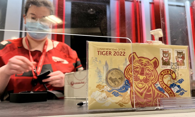 A coin and stamps for the Year of Tiger is seen in a post office in Sydney, Australia, on Jan. 13, 2022.(Photo: Xinhua)