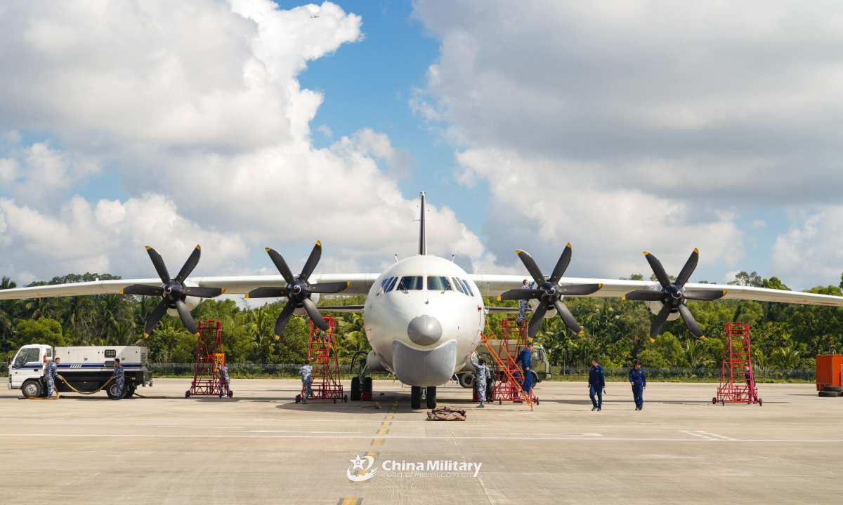 Maintenance men assigned to a naval aviation regiment under the PLA Southern Theater Command perform inspections on an anti-submarine patrol aircraft during flight training on January 6, 2022. (eng.chinamil.com.cn/Photo by Qin Qianjiang)