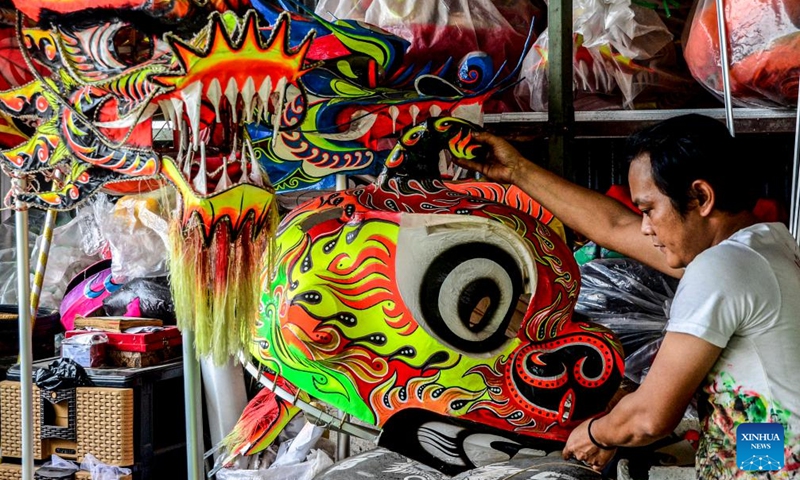 A worker holds a newly-made traditional lion head for the upcoming Chinese New Year celebration in Bogor, West Java, Indonesia, on Jan. 15, 2022.Photo:Xinhua