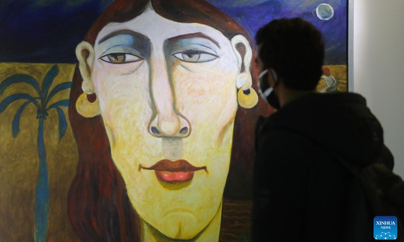 A visitor views a painting at an art exhibition during Egypt's 1st World Art Forum in Cairo, Egypt, on Jan. 16, 2022.(Photo: Xinhua)