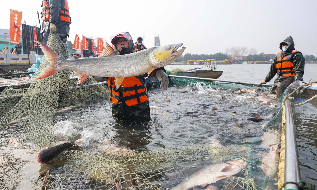 A fisherman in Taizhou, East China's Jiangsu Province displays his haul on January 18, 2022. Chinese people are getting ready for the upcoming Chinese New Year, snapping up fish, seafood and daily necessities. Photo: cnsphoto