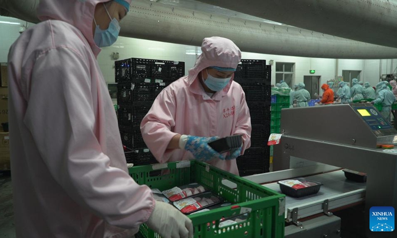 Workers seal chicken and half-prepared hotpot packages in Hainan (Tanniu) Wenchang Chicken Co., Ltd. in south China's Hainan Province, Dec. 30, 2021.(Photo: Xinhua)